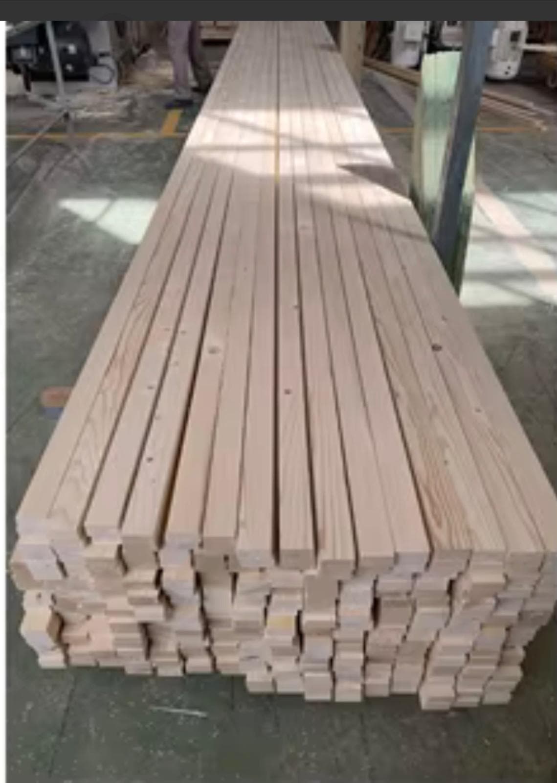 Structural construction wood beams aligned in long rows for building supply